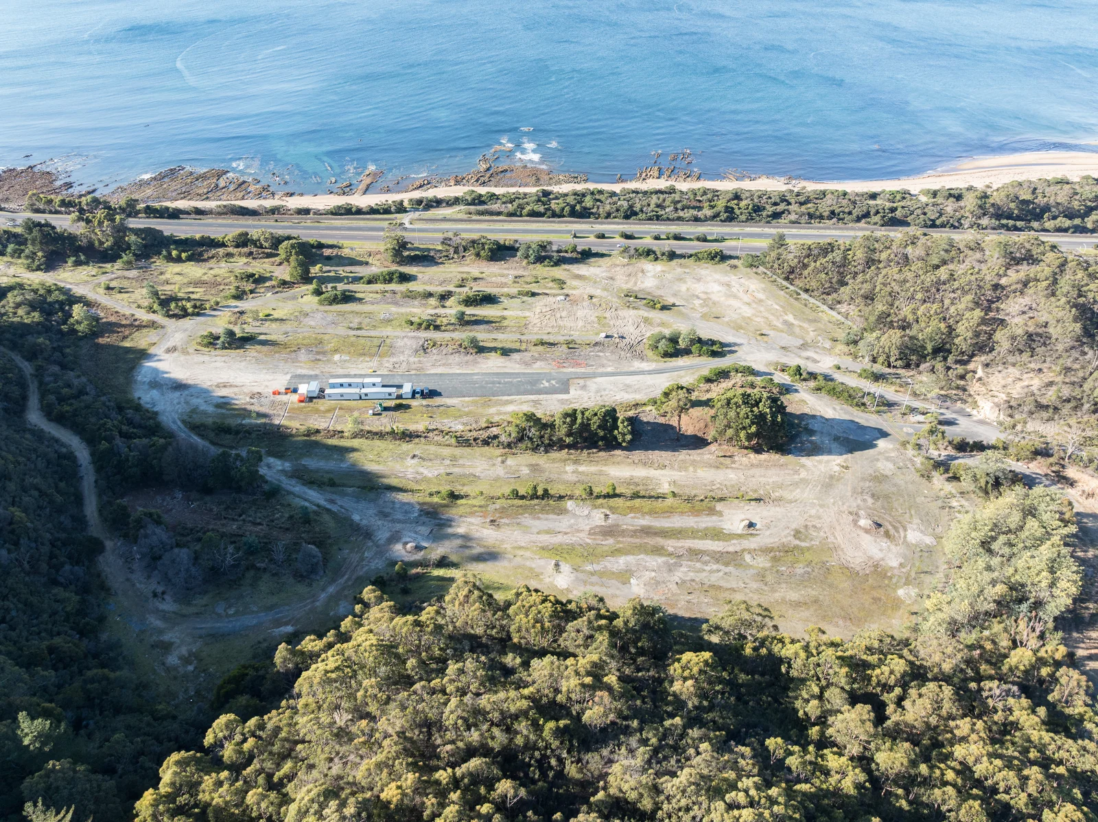 Aerial view of early site works at the Heybridge converter station, with the temporary compound and Bass Strait beyond